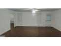 Bright living room with hardwood floors, neutral walls, ceiling fan and natural light from windows at 1581 Jersey Social Circle Rd, Covington, GA 30014