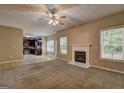 Spacious living room with fireplace and access to an adjacent kitchen area at 2093 Parador Bnd, Mcdonough, GA 30253