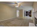 Open concept living room with carpet flooring and an inviting view to the kitchen at 2093 Parador Bnd, Mcdonough, GA 30253