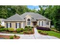 Charming stucco home featuring a well-manicured front yard, walkway, and stylish windows at 285 Spear Rd, Peachtree City, GA 30269