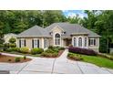 Charming home featuring manicured landscaping, a welcoming walkway, and elegant architectural details at 285 Spear Rd, Peachtree City, GA 30269