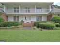 Inviting front entrance featuring a brick pathway, covered porch, and manicured landscaping at 550 Hawthorne Dr, Fayetteville, GA 30214