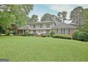 Charming two-story brick home with a second story balcony and a well-manicured lawn at 550 Hawthorne Dr, Fayetteville, GA 30214