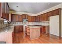 Spacious kitchen with wood cabinets, a center island, granite countertops, and hardwood floors at 1132 Hargrove Ct, Locust Grove, GA 30248