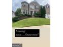 Charming two-story brick home with manicured landscaping and a welcoming front entrance at 3717 Shady Maple Dr, Stonecrest, GA 30038