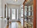 Bright foyer with hardwood floors, a glass cabinet and a glimpse of the dining room in the background at 505 Bracken Edge, Peachtree City, GA 30269
