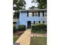 Charming blue townhome featuring black shutters, a black front door, and well-maintained landscaping at 375 Leisure Sw Ct, Marietta, GA 30064