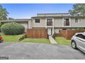 Inviting townhouse featuring wood fencing, well-manicured lawn, and upper level balconies at 292 Twiggs Cor, Peachtree City, GA 30269