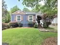 Charming home featuring a landscaped front yard, stone walkway, and inviting curb appeal at 3226 Hope St, Hapeville, GA 30354