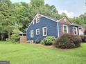View of a home with a spacious lawn and landscaping at 3226 Hope St, Hapeville, GA 30354
