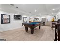 Finished basement with pool table, entertainment area, wet bar, and stylish flooring at 4030 River Ridge Chase Se, Marietta, GA 30067