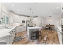 Bright kitchen features an island with seating, stainless appliances, and decorative wood flooring at 4030 River Ridge Chase Se, Marietta, GA 30067