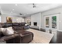 Cozy living room with a stone fireplace, recessed lighting, ceiling fans and access to the backyard at 4030 River Ridge Chase Se, Marietta, GA 30067