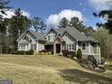 Inviting two-story home boasting stone details, professional landscaping, and pristine lawn at 265 Beverly Farms Dr, Sharpsburg, GA 30277
