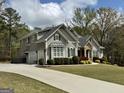 Charming home with a winding driveway, two-car garage, and meticulously maintained landscaping at 265 Beverly Farms Dr, Sharpsburg, GA 30277