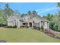 Charming gray home on a lush green lawn with a basketball hoop and a landscaped yard at 265 Beverly Farms Dr, Sharpsburg, GA 30277