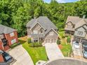 Aerial view of a stunning two-story home surrounded by lush greenery and well-maintained landscaping at 931 Hidden Falls Se Ln, Smyrna, GA 30082