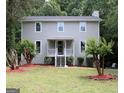 Charming two-story home with a well-maintained lawn and inviting front porch at 3858 Trenton Dr, Snellville, GA 30039