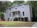 Side view of a two-story home with a well-maintained lawn and front porch at 3858 Trenton Dr, Snellville, GA 30039