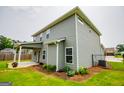 View of the rear of the house and the backyard at 309 Dean Ct, Temple, GA 30179