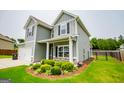 View of the right side of the house and the landscaping at 309 Dean Ct, Temple, GA 30179