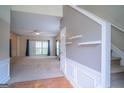 Spacious living room with natural light, neutral carpet, and staircase entry at 2938 Cottesford Se Way, Smyrna, GA 30080