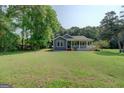 Charming single-story home featuring a spacious porch and a well-maintained, expansive front lawn at 315 Jewel Ln, Covington, GA 30014
