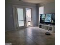 Cozy living room features tile floors, a sliding door to the outside, and a modern entertainment setup at 2540 Picardy N Cir # B, South Fulton, GA 30349