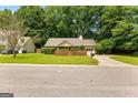 Well-kept suburban home with a fenced front yard and green lawn at 110 Long Leaf, Peachtree City, GA 30269