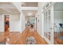Welcoming foyer with gleaming hardwood floors and natural light highlighting the coffered ceiling detail at 1979 Alcovy Shoals Blf, Lawrenceville, GA 30045