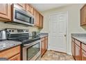 Efficient kitchen featuring stainless steel appliances, ample counter space, and wood cabinetry at 12303 Waldrop Pl, Decatur, GA 30034