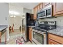 Well-lit kitchen with stainless steel appliances offering backyard access to dining and living area at 12303 Waldrop Pl, Decatur, GA 30034