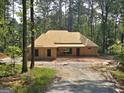 New construction home in a wooded area, featuring a simple design and natural surroundings at 2043 Fischer Rd, Sharpsburg, GA 30277