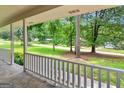 View from the porch, showcasing the property's lush greenery, mature trees, and neighborhood at 90 Country Roads Cir, Stockbridge, GA 30281