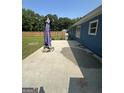 Concrete patio in a spacious backyard, featuring a grill and partial fencing at 160 Springdale Ct, Newborn, GA 30056