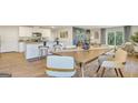 Open-concept dining area adjacent to the kitchen, featuring modern furnishings and natural light at 5455 Baybrook Cir, South Fulton, GA 30349