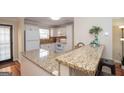 Bright kitchen features a breakfast bar with granite countertops and modern appliances at 482 N Jeff Davis Dr, Fayetteville, GA 30214
