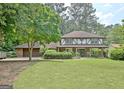 Traditional home with a spacious front yard, lush greenery, and a two-car garage at 212 Garret Rdg, Peachtree City, GA 30269
