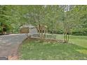Home exterior showcasing a white picket fence and long driveway to garage at 501 Bridlepath Ln, Peachtree City, GA 30269