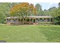 Brick ranch-style home featuring a beautiful maple tree and a well-kept lawn at 501 Bridlepath Ln, Peachtree City, GA 30269