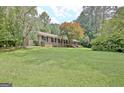 Well-maintained brick home with a sprawling green lawn and mature landscaping at 501 Bridlepath Ln, Peachtree City, GA 30269