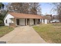 Exterior side view featuring a covered front porch and a concrete driveway at 108 Adrian Dr, Stockbridge, GA 30281