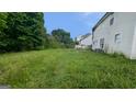 Large backyard needing some maintenance and showing the back of the house at 3679 Seabass Rd, Decatur, GA 30034