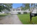 View of the home with a mailbox in the foreground and mature trees providing shade at 3679 Seabass Rd, Decatur, GA 30034