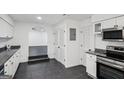 Modern kitchen featuring stainless steel appliances and white cabinets at 5490 Chemin De Vie, Sandy Springs, GA 30342