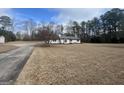 Charming single-story home with a well-maintained lawn and a long driveway at 120 Creekwood Ln, Fayetteville, GA 30214