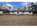 Charming single-story home with a well-maintained lawn and manicured landscaping at 120 Creekwood Ln, Fayetteville, GA 30214