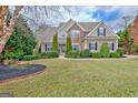 Beautiful two-story home with manicured lawn and attractive landscaping at 135 Edgewater Trl, Fayetteville, GA 30215