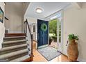 Inviting entryway with hardwood floors, staircase, and an open door showcasing the exterior at 108 Summit Walk, Peachtree City, GA 30269