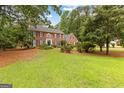 Two-story brick home with mature trees and landscaping in a tranquil setting at 108 Summit Walk, Peachtree City, GA 30269